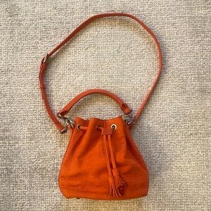Emily Cho New York leather medium crossbody bucket bag in bright orange color